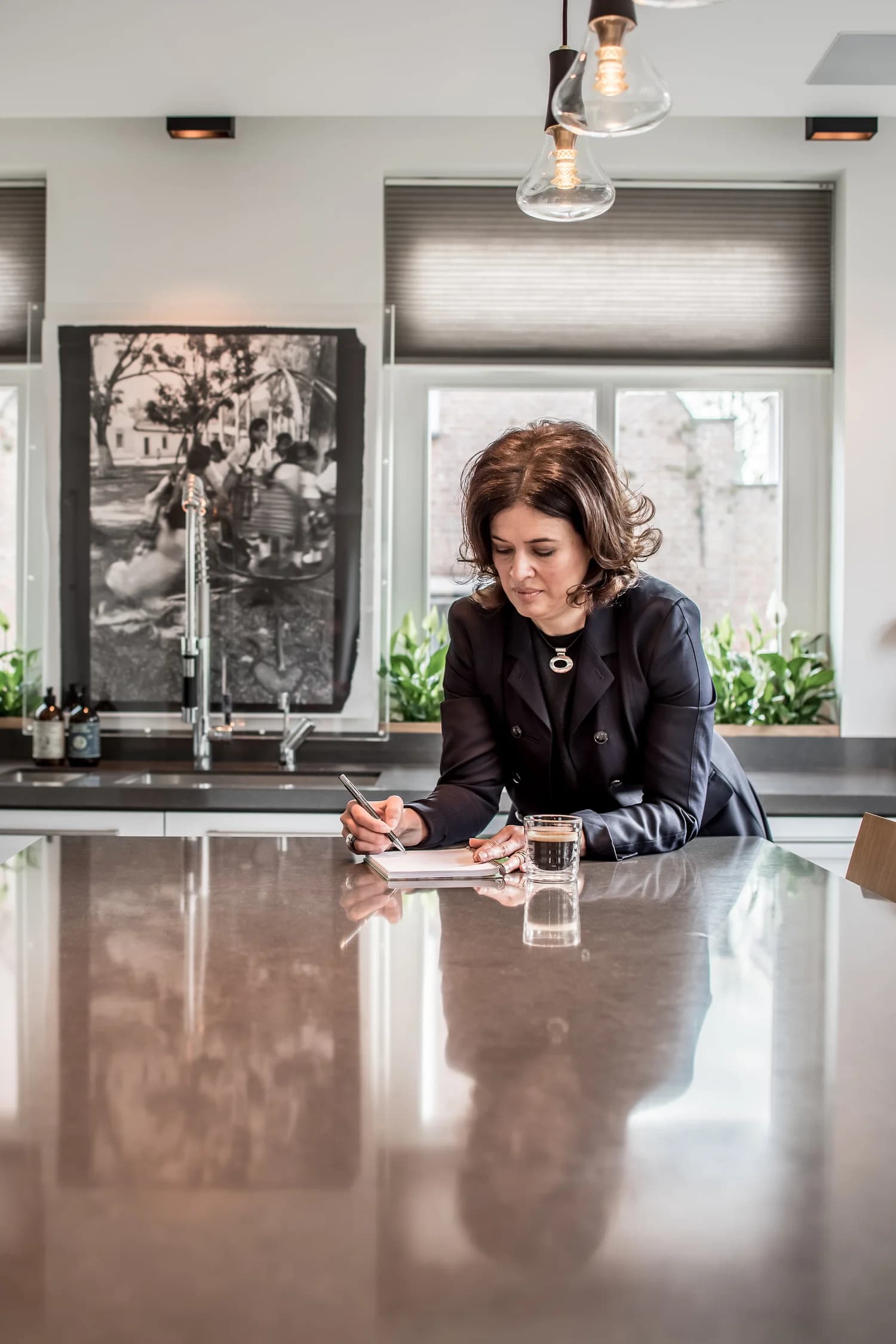 Interior architect Valery Chong sketching at the kitchen island in Villa Wassenaar.